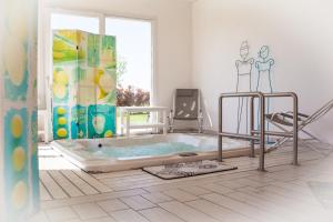 a bathroom with a jacuzzi tub in a room at Il Giardino Di Rebecca in Ferrara