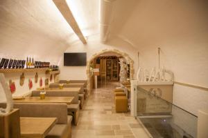 a restaurant with chairs and tables in a room at IL Borgo Relais in Gravina in Puglia