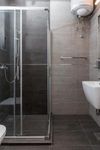 a shower with a glass door in a bathroom at Apartments Green Scenic in Dubrovnik +56 photos
