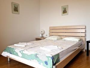 a bedroom with a bed with two towels on it at Belvedere Apartments in Byala