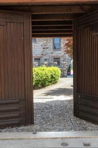 an open door to a building with a brick wall at Al Sa di Te in Udine