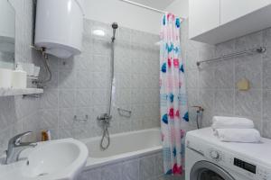 a bathroom with a sink and a tub and a washing machine at Apartment Jakov i Lucija in Dubrovnik +36 photos