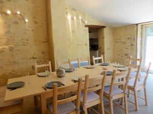 a dining room with a wooden table and chairs at La Bergerie De Vaison in Entrechaux