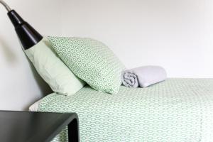 a bed with two pillows on top of it at Cozy studio near University of Turku in Turku