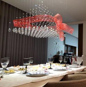 a dining room table with a red chandelier at Luxury 3 Bedroom Penthouse With Private Garage in Braga