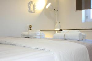 a hotel room with a bed with towels on it at Persephone in Ioulis