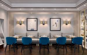 a dining room with a long table and blue chairs at InterContinental Sofia by IHG in Sofia