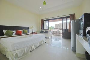 a bedroom with a large bed and a large window at Buathong Place in Lamai