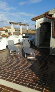 two chairs sitting on top of a patio at Apartment Tijano in Krnica