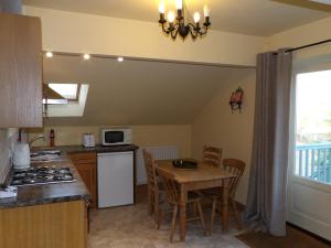 a kitchen with a table and a dining room at Broccoli Bottom in Oakham