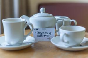 two cups and a tea set on a table at Skeffington Arms Hotel in Galway