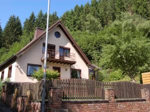 a house with a fence in front of it at Holiday home with garden in Hellenthal Eifel in Hellenthal