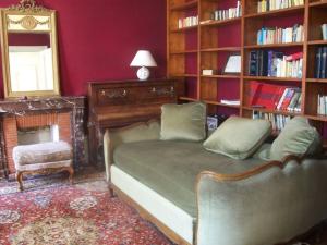 a bedroom with a bed and a book shelf at Château Fontclaire in Pons