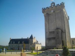 a building with a tower with a clock on it at Château Fontclaire in Pons