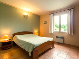 a bedroom with a bed and a window at Colourful Holiday Home in Noves with Swimming Pool in Noves