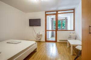 ブカレストにあるResidence 30のベッドとテレビと窓のある寝室