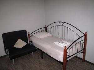 a bed and a chair in a room at Great view apartment near Piazza Batumi in Batumi