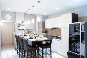 a kitchen with a table with chairs and a refrigerator at Bed & Breakfast Armonie Romane in Rome +44 photos
