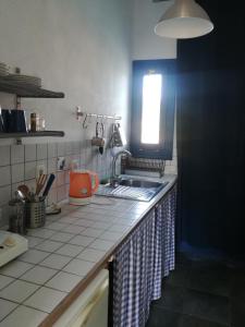 a kitchen counter with a sink and a window at Ikion Studios in Steni Vala Alonissos