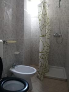 a bathroom with a shower and a toilet and a sink at Appartamenti La Spiaggia in Gallipoli