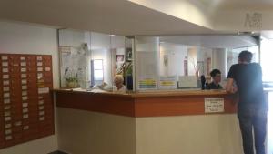 a man standing at a counter in a store at Hostel Strahov in Prague