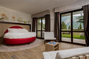 a bedroom with a large bed and a living room at Hotel Griso Collection in Malgrate