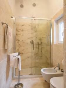 a bathroom with a shower and a toilet and a sink at Appartamento in Palazzo Bucelli in Montepulciano +43 photos