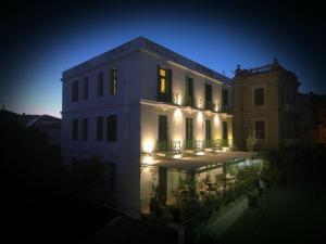 a large white building with lights on it at night at Orfeas Hotel in Mytilini