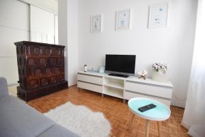 a living room with a couch and a tv on a desk at Sun and sea apartment in Zadar