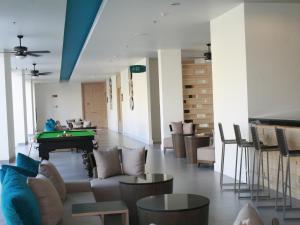 a living room with a pool table and couches at Ibis Phuket Kata in Kata Beach