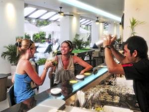 a group of people standing around a bar with drinks at Ibis Phuket Kata in Kata Beach
