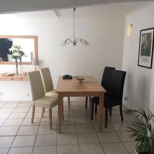 a dining room with a table and chairs at Riverside Barn in La Trimouille