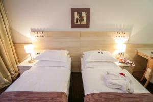 Postel nebo postele na pokoji v ubytování Hotel Trakošćan