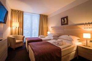 Postel nebo postele na pokoji v ubytování Hotel Trakošćan