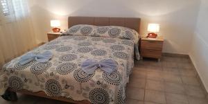 a bedroom with a bed with bows on it at Apartments Miro with Sea view - near Beach in Sumartin