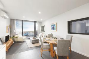 A television and/or entertainment center at Ascent Apartment with Ocean Views by Ready Set Host