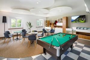 a billiard room with a pool table at Hotel Bellinzona Sud Swiss Quality in Monte Carasso
