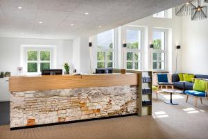an office with a stone fireplace in a lobby at Hotel Bellinzona Sud Swiss Quality in Monte Carasso