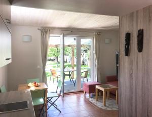 a living room with a door to a patio with a table at Namelis Palangoje in Palanga +8 photos