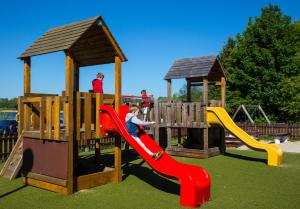 two children playing on a playground with a slide at Fontána Lipno in Černá v Pošumaví