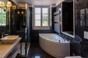 a large bathroom with a tub and a sink at Mediterraneo Emotional Hotel & Spa in Santa Margherita Ligure