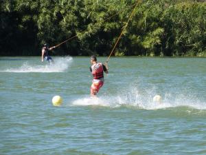 two men are water skiing on a lake at Maison MICDEN in Saint-Jean-Pla-de-Corts