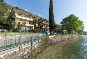 a building on the side of a river at Residence Sporting in Malcesine