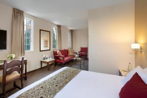 una camera d'albergo con un letto e un soggiorno di YMCA Three Arches Hotel a Gerusalemme
