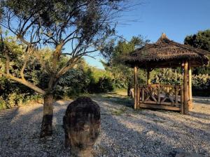 a small hut with a statue in front of it at Mas à Cheval-Blanc en Provence in Cheval-Blanc