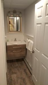 a bathroom with a sink and a mirror at Atlantic Motel in Point Pleasant Beach