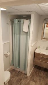 a bathroom with a shower and a toilet and a sink at Atlantic Motel in Point Pleasant Beach