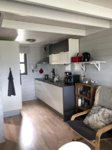 a kitchen with a couch and a counter in a room at Voss Hytte/Cabin in Skulestadmo