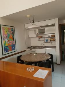 a small kitchen with a table and a dining room at Residence I Boboli BC in Punta Ala