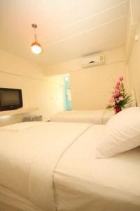 Postel nebo postele na pokoji v ubytování O.U.M. Hotel - โรงแรมโอยูเอ็ม